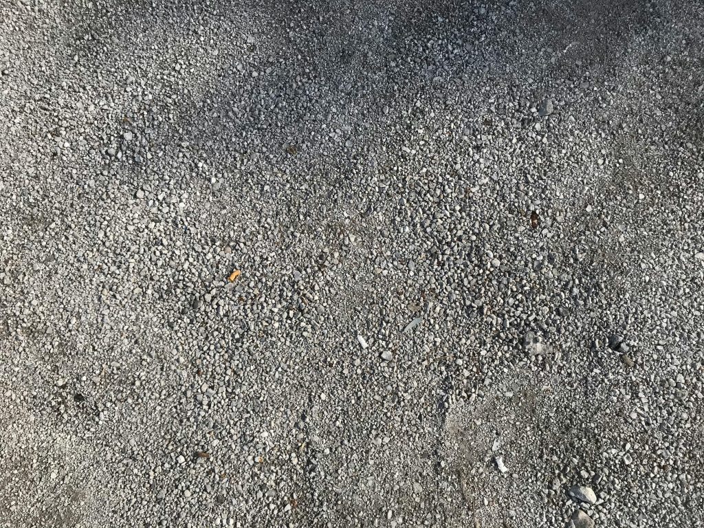 Close-up of gray gravel texture on a concrete floor, perfect for backgrounds.